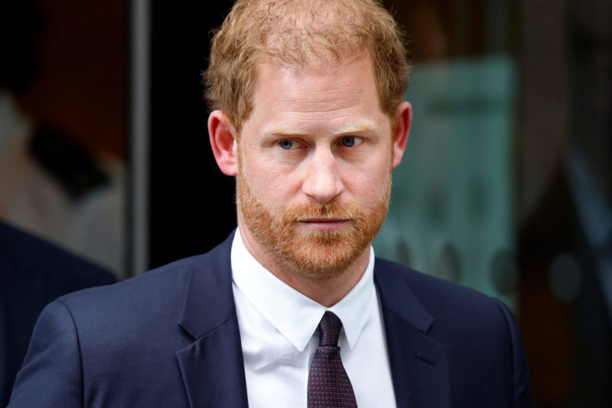 Why does Prince Harry tuck his hands in his coat during public appearances