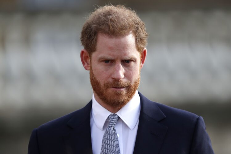 (FILES) In this file photo taken on January 16, 2020, Britain's Prince Harry, Duke of Sussex watches children play rugby league prior to the draw for the Rugby League World Cup 2021 at Buckingham Palace in London. - Britain's Prince Harry expressed "great sadness" on January 19, 202 at the way he and his wife Meghan had to give up their royal titles as part of a separation settlement with the Queen. (Photo by Adrian DENNIS / AFP)